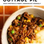 close up image of healthy beef and lentil cottage pie served in a white bowl