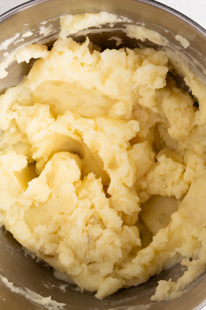 whipped mashed potatoes in metal bowl