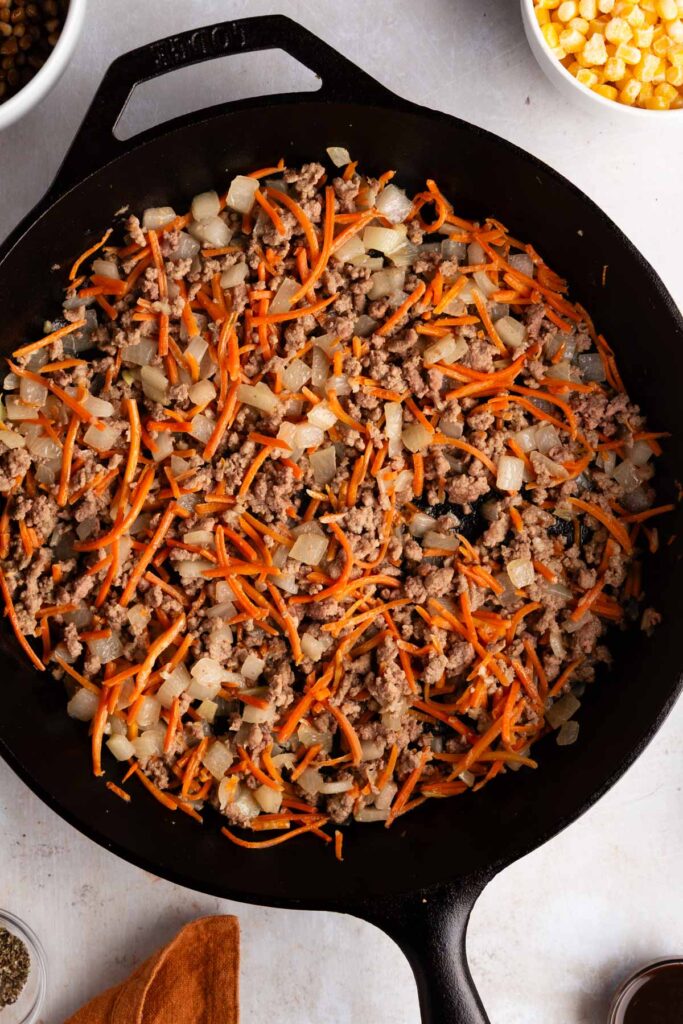 sauteeing onion and carrots and browning ground beef