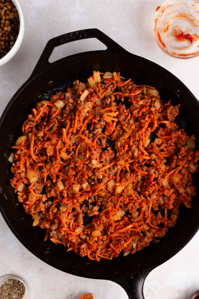 toasting tomato paste in skillet with veggies until fragrant