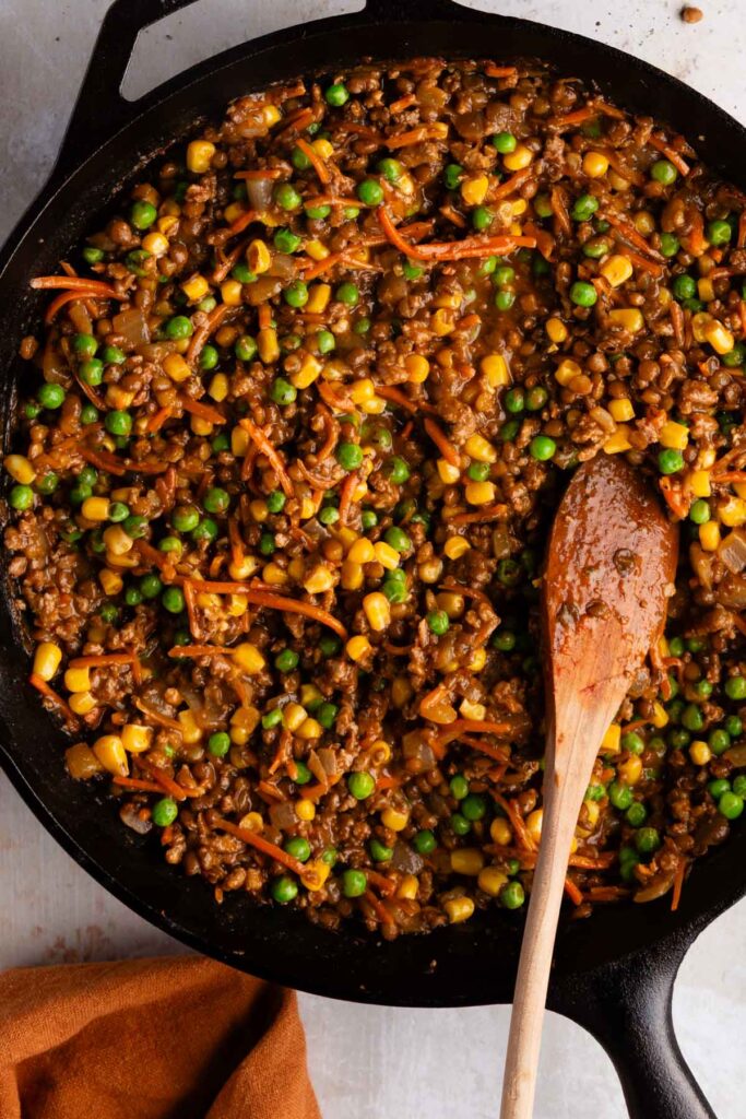 stirring in the frozen peas and corn