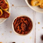 small bow of sun dried tomato pesto with bread for serving or dipping