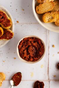 small bow of sun dried tomato pesto with bread for serving or dipping