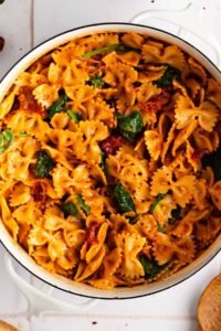 close up view of the pasta with sun dried tomato pesto in a white bowl
