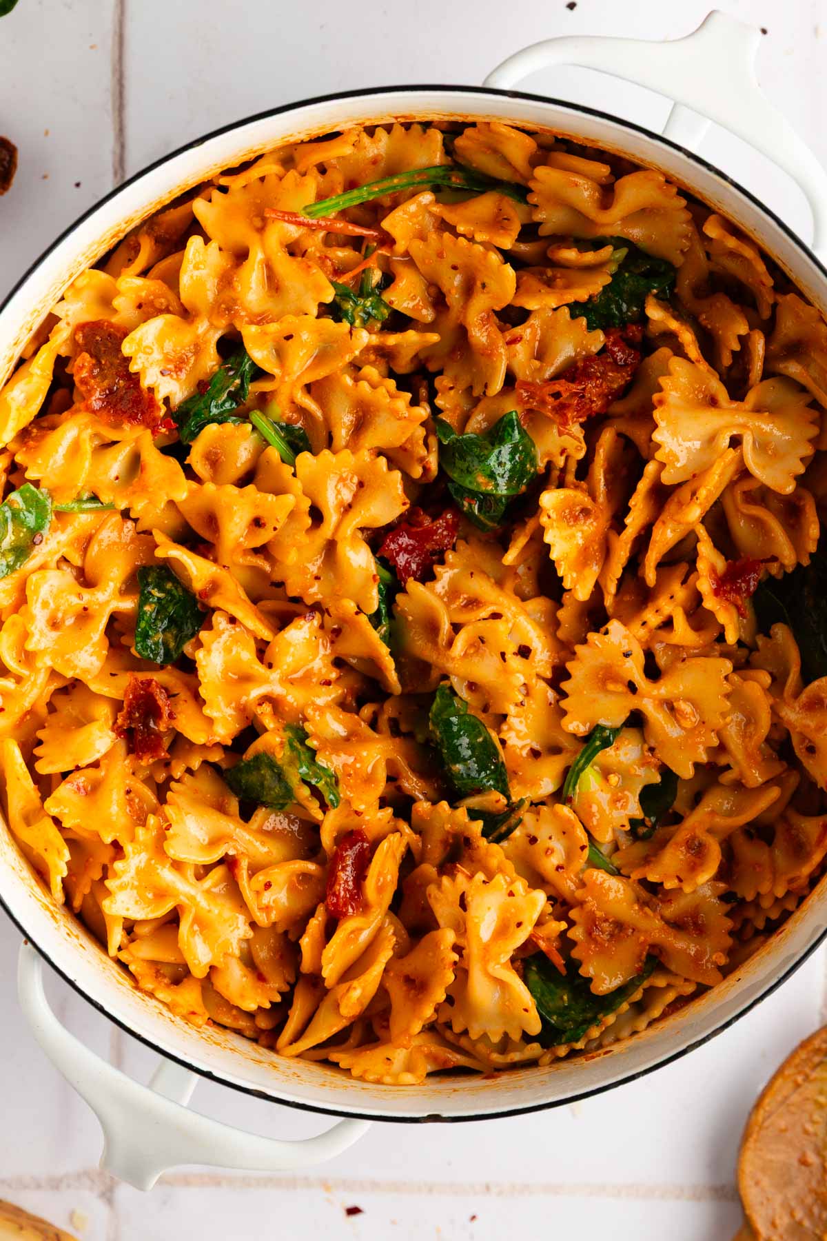 close up view of the pasta with sun dried tomato pesto in a white bowl