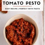 Pinterest image with bowl of sun dried pesto and working that reads the best sun dried tomato pesto