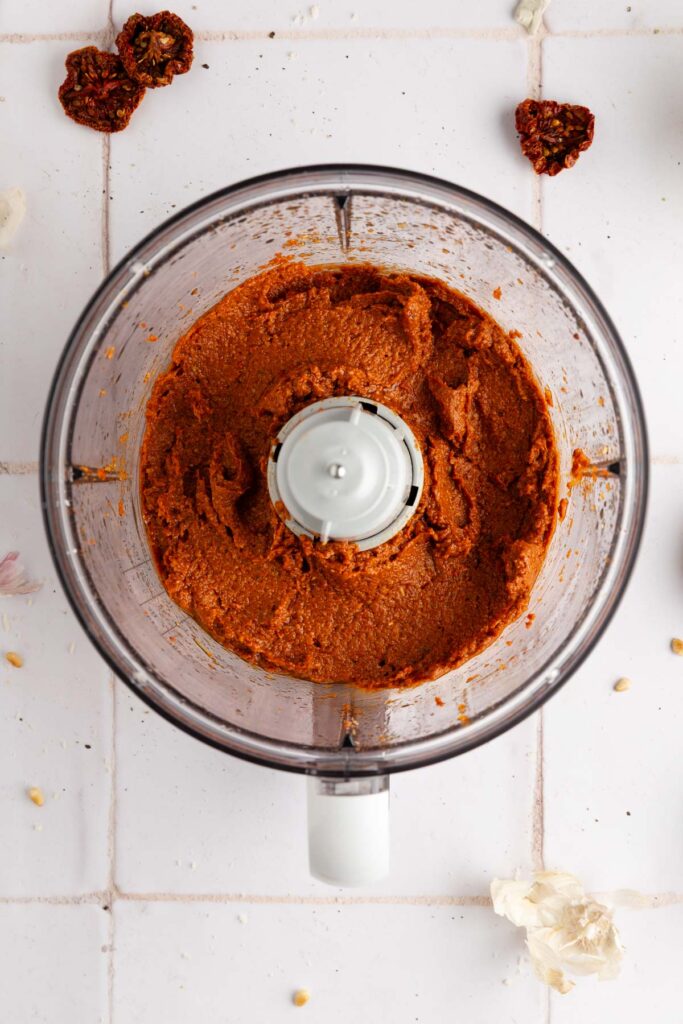 blending all the sun dried tomato pesto ingredients in the food processor until smooth