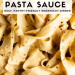 Close-up of fettuccine tossed in creamy chickpea pasta sauce with cracked black pepper