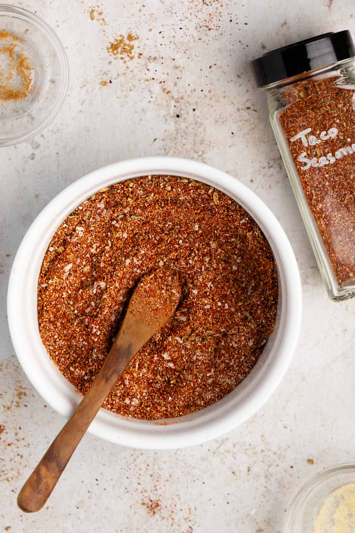 a while bowl of vegan taco seasoning with a little spoon inside