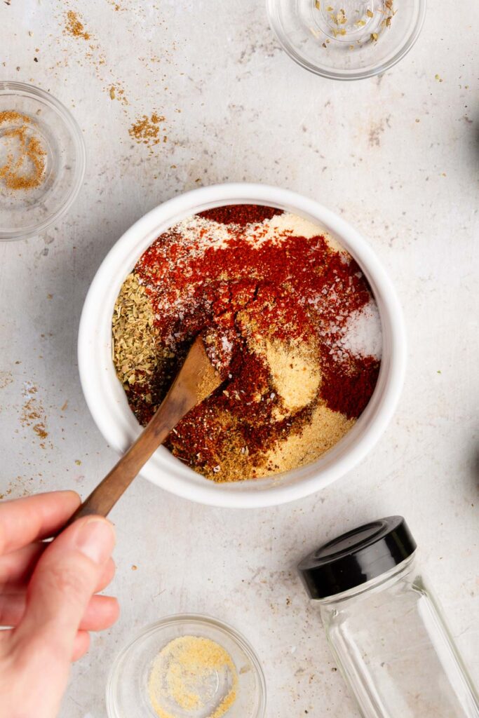 adding all the ingredients in a bowl to make the vegan taco seasoning