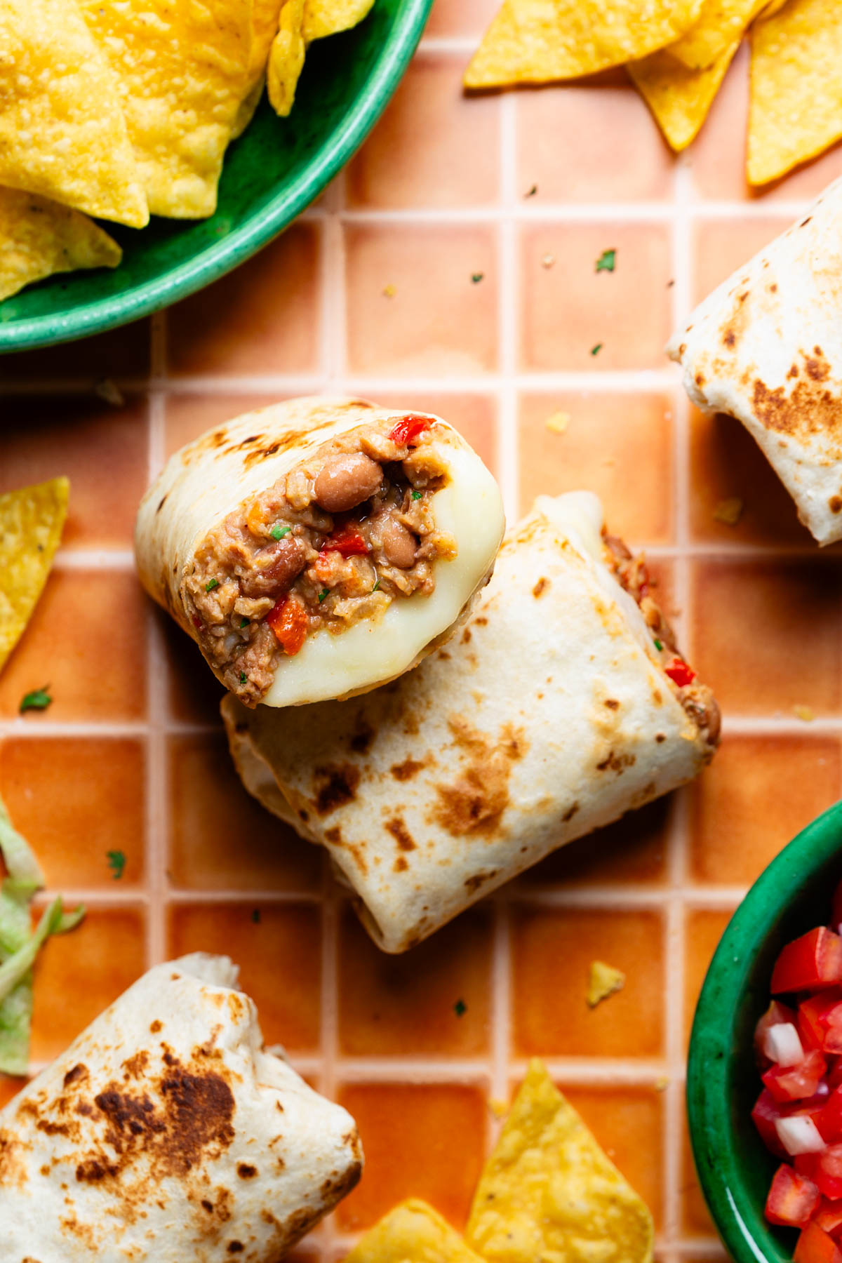 Cheesy Pinto Bean Burritos cut in half and stacked together.