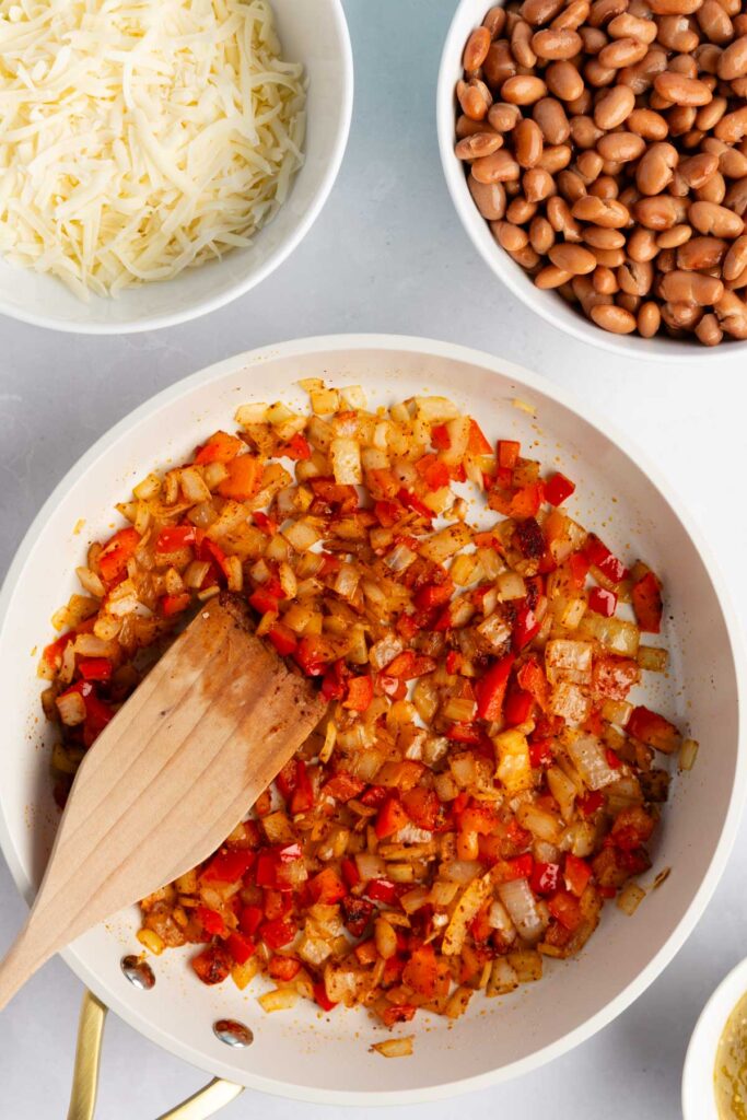 cooking the ingredients in a pan for the burrito filling