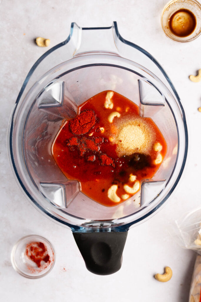 Adding all the ingredients into a blender to make dairy free wing sauce.