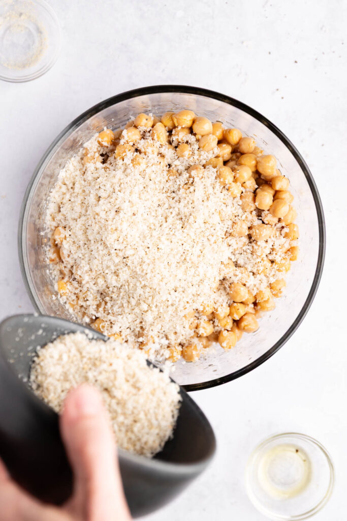 Adding oil and Parmesan cheese to the chickpeas.