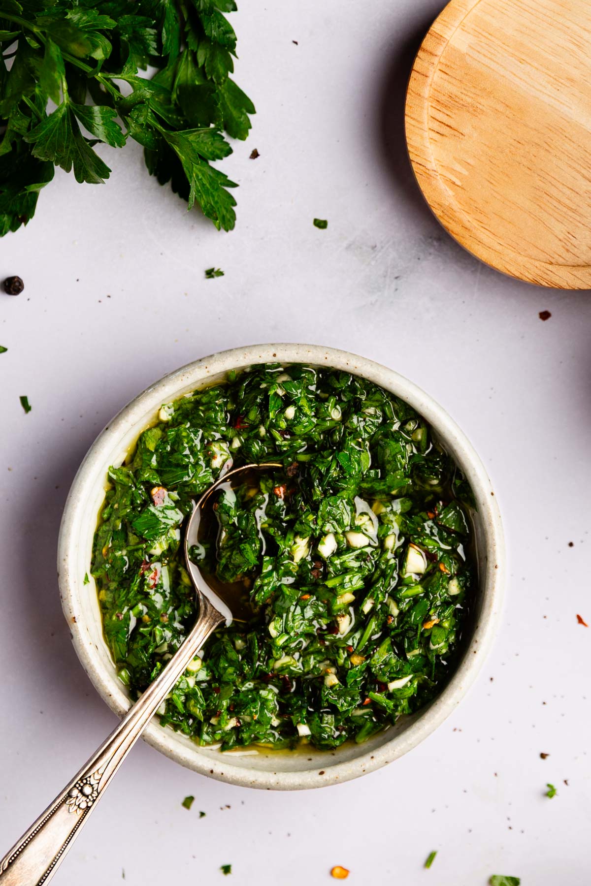 Bowl of garlic parsley sauce in a white bowl.