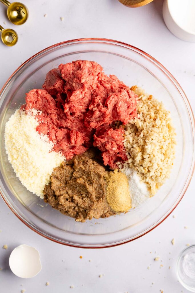 Adding in the rest of the ingredients for these beef and lentil meatballs.