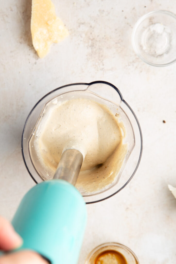immersion blender blending ingredients for a healthy caesar dressing made with cottage cheese 