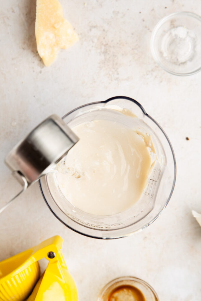 adding water to thin healthy caesar derssing made with cottage cheese