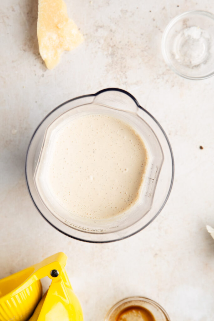 overhead of cottage cheese caesar dressing in a measuring container