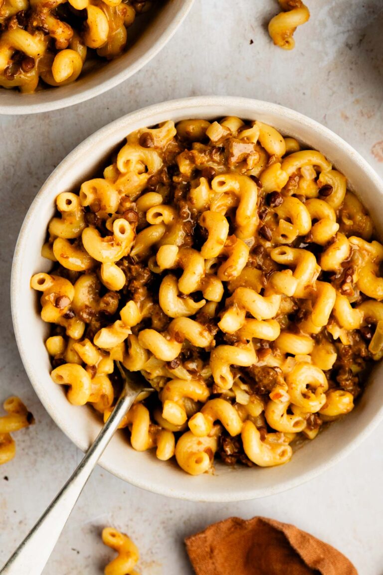 Bowl of healthy cheeseburger pasta with cavatappi pasta, ground beef, and lentils in a creamy cheese sauce.
