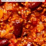 Close-up of a thick vegetarian chili with red kidney beans, TVP crumbles, diced onion and pepper in a glossy tomato sauce. A text box at the top reads Healthy Vegetarian Chili Recipe, easy one-pot dinner, high-protein. Plant-Forward Family logo at the bottom.